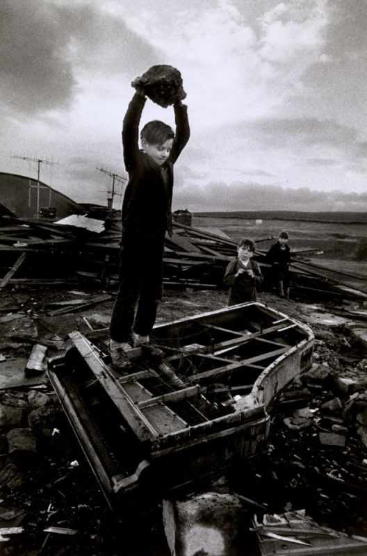 Boy destroying piano at Pant-y-Waen, South Wales, by Philip Jones Griffiths, 1961. Magnum Photos